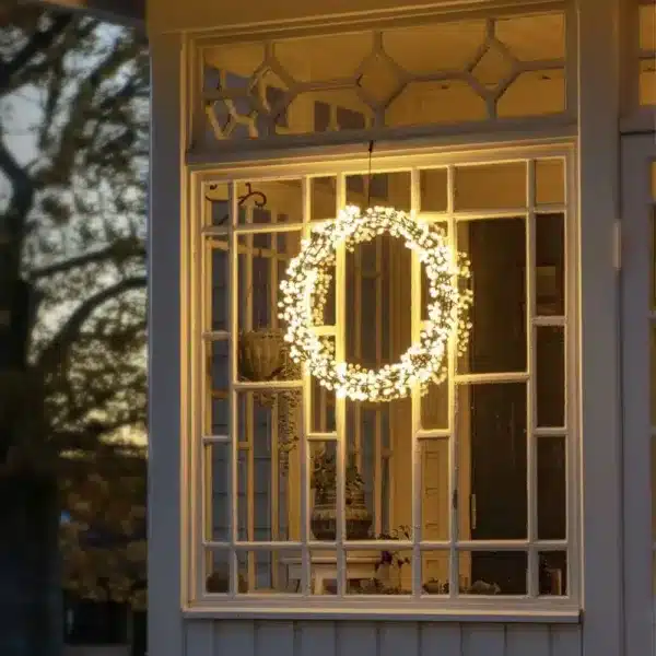 Black metal Christmas wreath window display