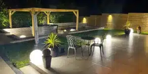 Garden lighting ideas with outdoor ball lamps, wall lights and patio seating in an Irish garden