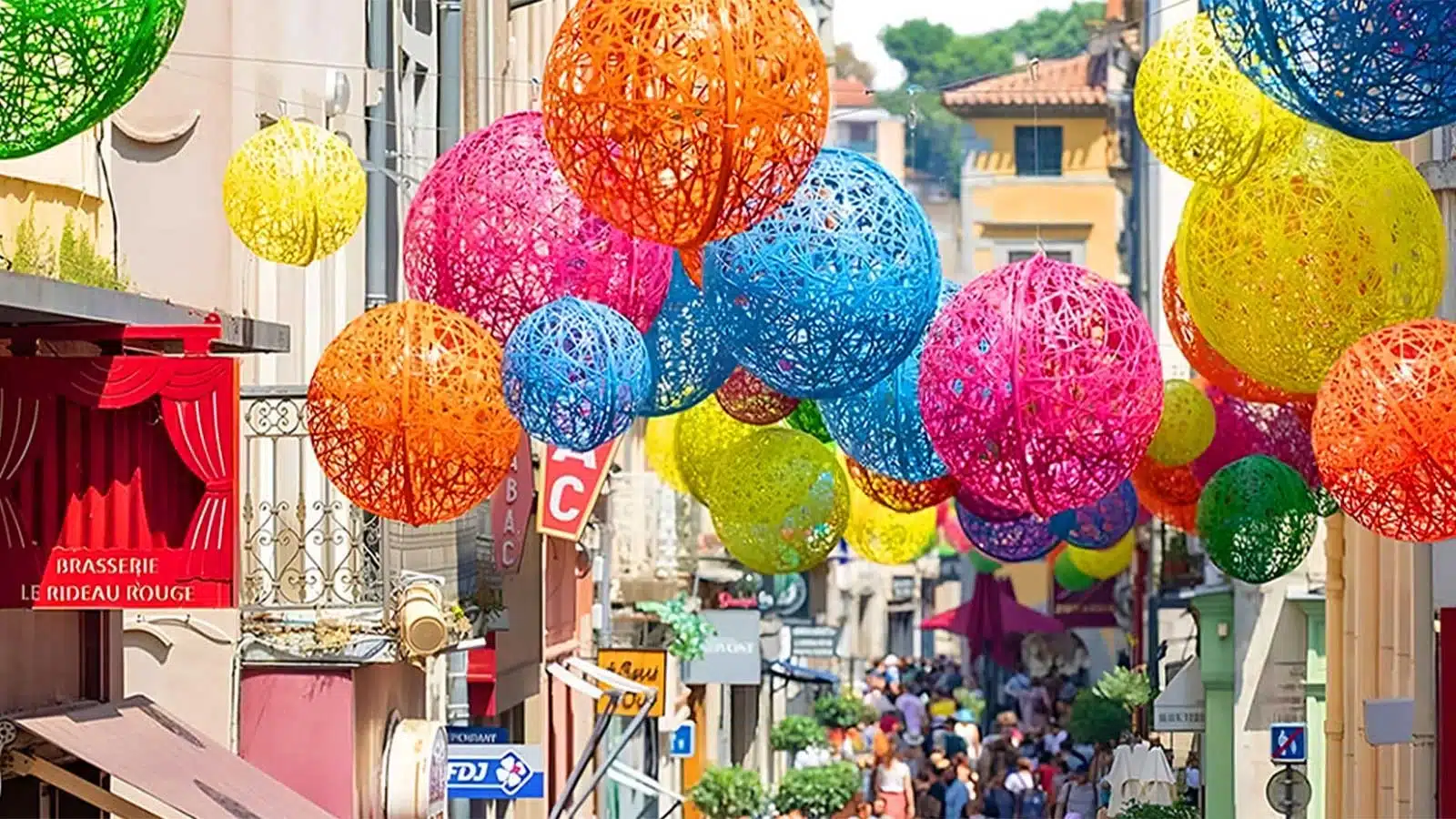 Colourful summertime decorations suspended above a busy street